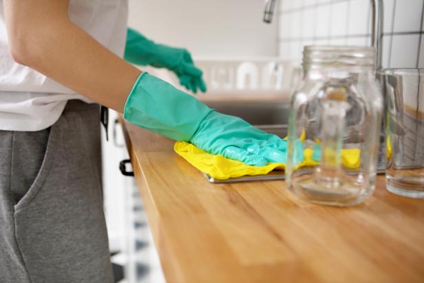 Young woman is cleaning the kitchen in home.