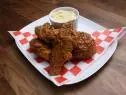 Anne Burrell's Fried Chicken with Maple Cayenne Sauce and Parmesan Polenta with Corn is displayed, as seen on Worst Cooks in America, Season 17.
