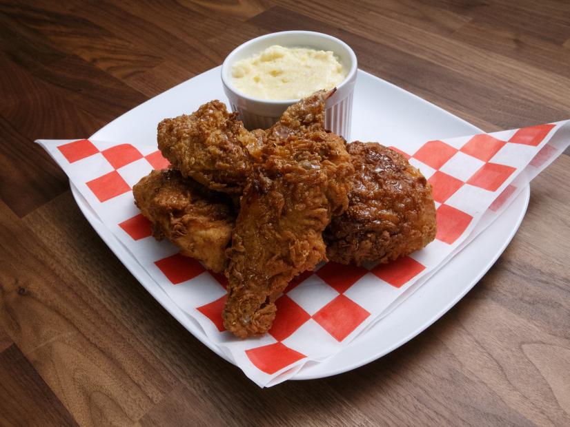 Anne Burrell's Fried Chicken with Maple Cayenne Sauce and Parmesan Polenta with Corn is displayed, as seen on Worst Cooks in America, Season 17.