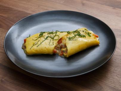 Bobby Flay's Omelette with Piquillo Peppers, Basil, Mozzarella and Prosciutto is displayed, as seen on Worst Cooks in America, Season 17.
