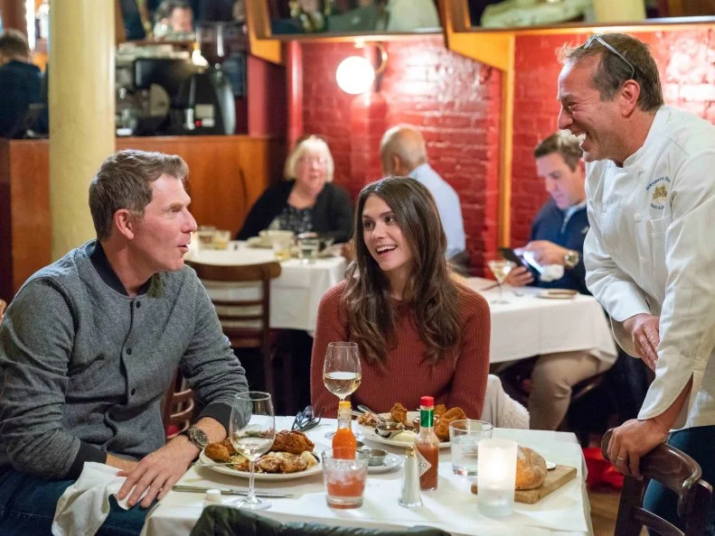 Host Bobby Flay and Sophie Flay with Chef Bruce Bromberg as they sample the Fried Chicken with Mashed potatoes and collard greens at Blue Ribbon Brasserie, as seen on Flay vs Flay, Season 1.