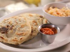 <p>After meeting at El Paso&rsquo;s culinary school, the chef-owners of this international joint decided to open a place downtown serving up the dishes they grew up with, like pupusas from El Salvador. These arepa-like breads are made from fine ground masa and are and stuffed with house-made Salvadorian chicharron, a spiced ground pork. Three come in a serving, but you won&rsquo;t want to stop there: &ldquo;I could have 500 of these,&rdquo; Guy said.</p>