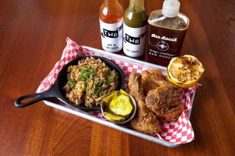 "Fried chicken takes time,” says Thomas Dunklin, co-owner and chef of The Waiting Room in Portland. “We have a special brine and flour mix that we make in house,” which takes four days to prepare. Served with charred lemon and bread-and-butter pickles, the chicken is even better doused with Bee Local’s cherrywood-smoked housemade, barrel-aged hot sauces.
