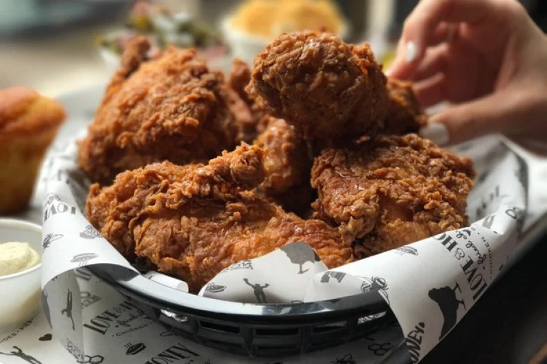 In Philadelphia diners crowd the restaurant to indulge in Love & Honey Fried Chicken’s famous bird. Each piece of poultry is brined for eight hours, coated in buttermilk and seasoned flour, fried and finished off with honey to add a sweet-meets-salty element to the dish.