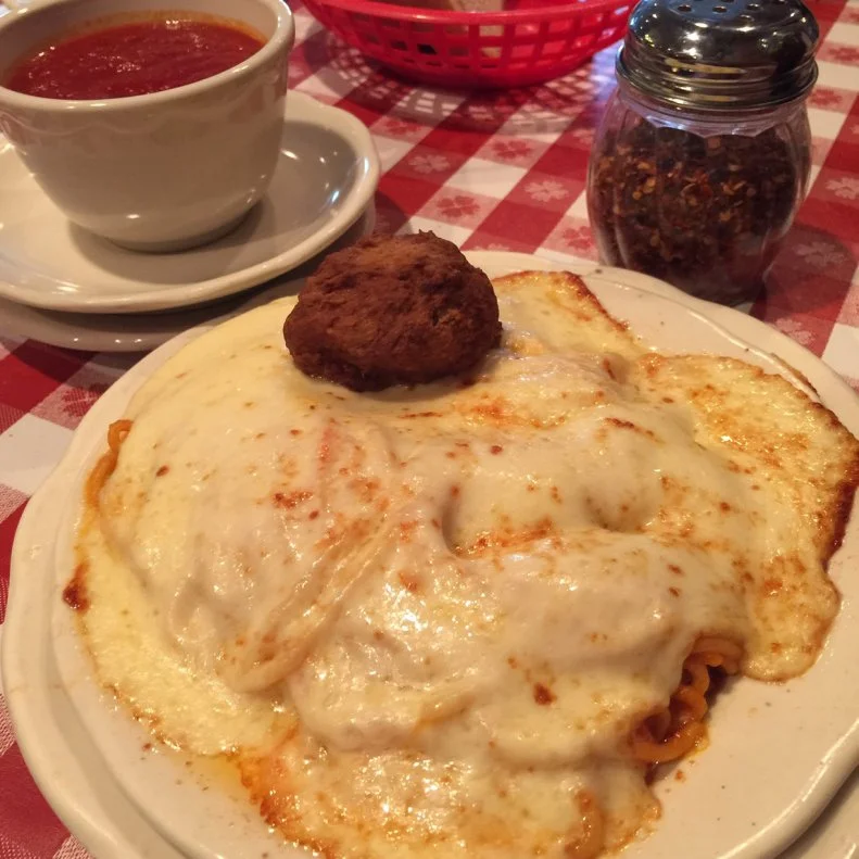 Chef’s Restaurant has been a downtown Buffalo icon since 1923. The classic family restaurant is decked out with red-and-white-checkered tablecloths and autographed photos of celebrity fans who love the traditional Italian-American red sauce-style fare. The most-popular dish on the menu — a relative newcomer, added in 1962 — is the spaghetti parm. The pasta, the most-famous in Buffalo, is so beloved, it’s considered the go-to for many celebratory occasions and milestones. It features spaghetti, tossed in sauce and butter, sprinkled with Parmesan and Romano and covered with slices of mozzarella cheese, then tossed under the broiler until the cheese melts. Those delicious ingredients come together on the fork, when locals twirl it together and dunk it into marinara sauce.