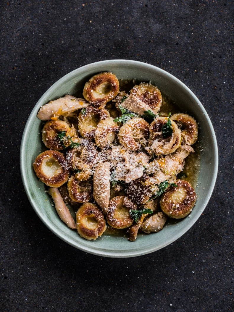 James Beard-winning chef Tandy Wilson’s City House has created its own category of cuisine. The Italian-inspired Southern restaurant sources all of its ingredients from local farms, aiming to be as sustainable as possible and while wasting as little as they can. His gnocchi is made from the same recipe as the pizza dough (which is a must-try if you go) with the addition of milk and egg. The result is light and airy, but what sets it apart from other versions is the crisp crust that develops when it’s pan-seared. Those chewy rounds are finishes in the rabbit sugo, rabbit braised in a fennel-scented sofrito and house brodo (bone broth of pork, and chicken), and topped off with fresh parsley and Grana Padano, so it’s rich, crisp and packed full of flavor.