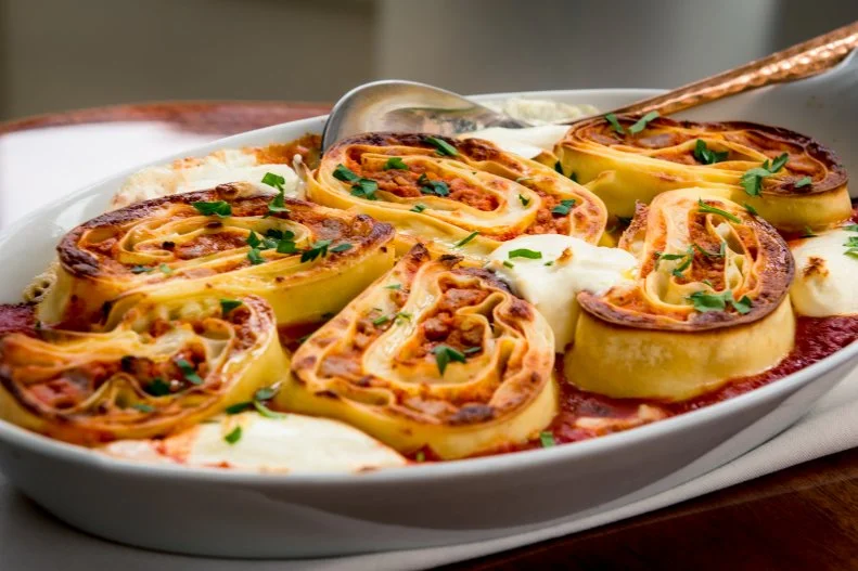 Inspired by cinnamon buns baked in a casserole dish, husband-and-wife wonder duo Angie Rito and Scott Tacinelli decided to roll up some lasagna and bake it the same way. Don Angie’s resulting large-format dish is made with fresh house-made pasta, rolled into rosettes, filled with layers of sweet Italian sausage, Bolognese sauce and besciamella (essentially an Italian version of roux), then layered with mozzarella and 24-month Parmigiano Reggiano. Each rosette is baked in a bright San Marzano tomato sauce with dollops of fresh robiola cheese, then finished with chopped parsley and a side of garlic focaccia. Every single bite is the like perfect corner piece with an ideal textural contrast of delicate pasta and crispy top. And it’s easy enough to share that you might stand of a chance of keeping some of that delicious red sauce off your shirt.