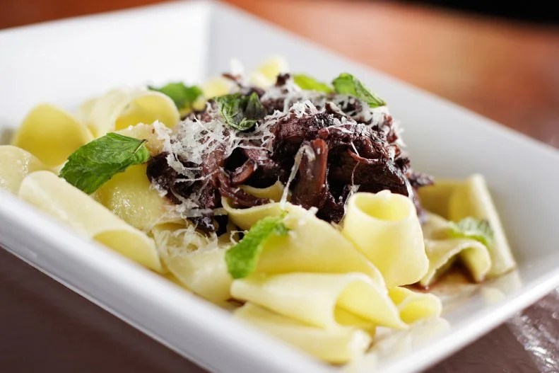 James Beard-nominee Anna Vogel serves an excellent menu of regional Italian fare at her lively Spokane restaurant. Pasta only makes up a short portion of Italia Trattoria’s menu, but the options are all impressive, including pappardelle lamb ragu that is the house specialty. Inspired by the rustic Italian style of roasting meat on the bone, then braising it low and slow until fork tender, red wine-braised lamb ragu is the base of this bold dish. The garlic- and rosemary-infused sauce is served atop housemade semolina pappardelle pasta, finished with grated pecorino romano cheese and fresh mint.