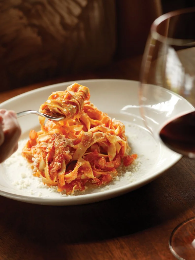 One of greatest culinary influences on Nostrana chef-owner Cathy Whims was Italian-born chef and author Marcella Hazan, who invited Whims to study at her Venice home. Whims pays homage to her mentor by featuring Hazan’s most-famous sauce almost daily on the menu at her Portland restaurant. The dish perfectly simple with handmade farm-fresh egg fettuccine that soaks up the mix of butter, San Marzano tomatoes and onions, fully absorbing all the flavor. As opposed to oil-based sauces that are slick over the noodles, butter sauce absorbs into handmade egg pasta like lotion, says Whims. “...This sauce is totally non-aggressive, delicious, pure and sweet. We then top it with the best Parmigiano Reggiano we can get, and it's magic.”