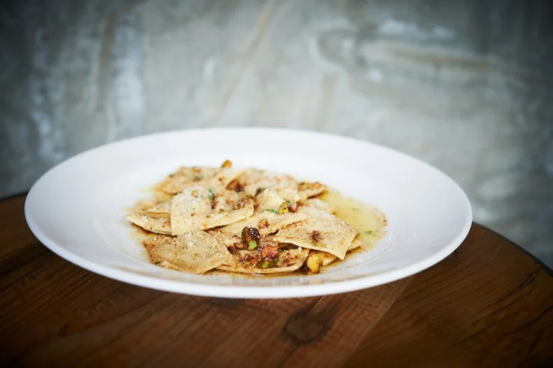 James Beard Award winner Gerard Craft really knows how to showcase pasta at his casual Italian concept, Pastaria. Guests can actually watch the chefs extruding pasta and hand-rolling ravioli in the kitchen through a glass window. The dishes exceed the show. Pastaria’s Italian classics like Bucatini all’ Amatriciana excel, but they’re surpassed by Craft’s more personal, creative interpretations. The pistachio ravioli is one of the best things on the menu. The “happy accident” as it’s called, came about as Craft was working on a dish for his former fine dining concept. The chef made a pistachio filling that didn’t work out, but he kept it in mind until Pastaria opened, combining the creamy and nutty mix with mint, lemon brown butter and Grana Padano.