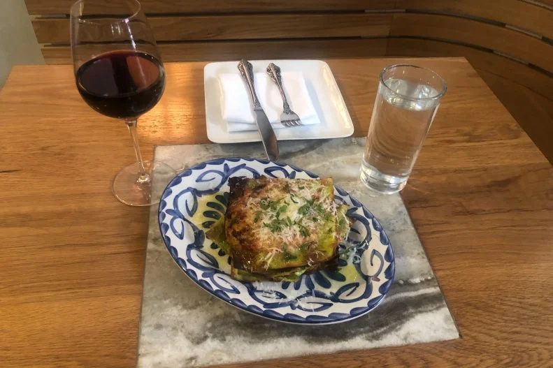 Converting what is normally a heavy and not-very-nutrient-rich dish into a lighter but equally delicious riff on layered pasta, the Tredici Enoteca team created lasagna verde. It’s become an icon for the restaurant. The pasta is made with 100% fresh spinach that’s blanched and pureed to produce the individual sheets. Unlike regular lasagna that’s assembled into a casserole dish and cooked all at once, this creative interpretation is built in individual layers that get cooked separately, so the edges crisp up and maintains a chewy texture throughout. Once those pieces come out of the oven, they’re stacked atop of one another with house-made pork bolognese and bechamel, then finished off with some fine herbs and grated Parmesan.