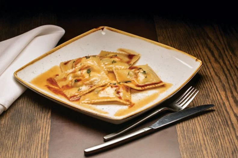 New York City often sucks the air out of the food scenes of its neighboring towns and cities. It’s not that there aren’t great chefs and restaurants nearby, there are just so many big names in the Big Apple, it takes a lot for those right outside the five boroughs to get noticed. Executive chef Giuseppe Fanelli of Tredici North, spent time working in NYC’s top Italian kitchens, from Felidia’s to Rao’s, before taking over the stove at this award-winning Westchester place. He offers a selection of creative spins on Italian classics such as the decadent Kobe beef ravioli, house-made ravioli filled with braised Kobe beef, caramelized onions, black truffle and Fontina di Val’Dosta cheese in browned butter and thyme, with natural reduction.