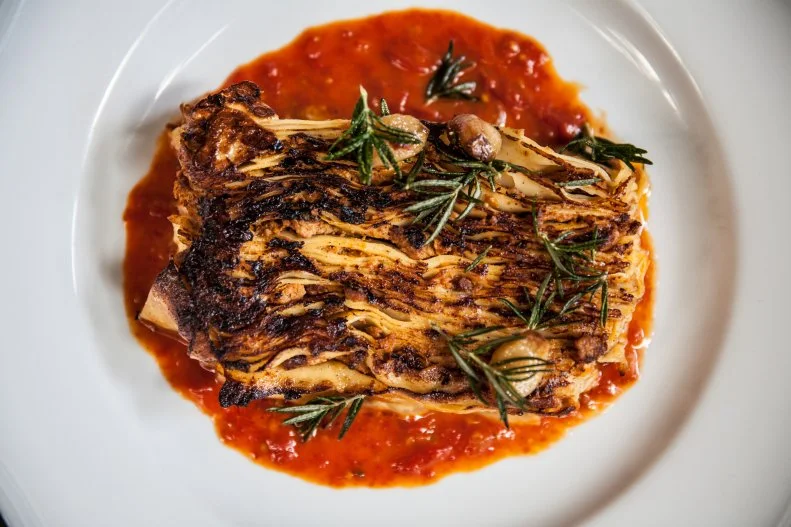The self-proclaimed world’s best Bolognese at Viale dei Romani is made via an elaborate, labor-intensive three-day process. It starts with an eight-hour simmer of milk- and tomato-braised veal with pork, which goes straight into the 100-layer lasagna, made in the traditional Emilia-Romagna style, with 50 sheets of pasta and 50 layers of Bolognese before it’s baked. To finish it off, Chef Casey Lane uses a piastra (a hot sheet of metal) to sear the lasagna sheet so it’s caramelized and crispy on top and then serves the lasagna over a very simple tomato jus.