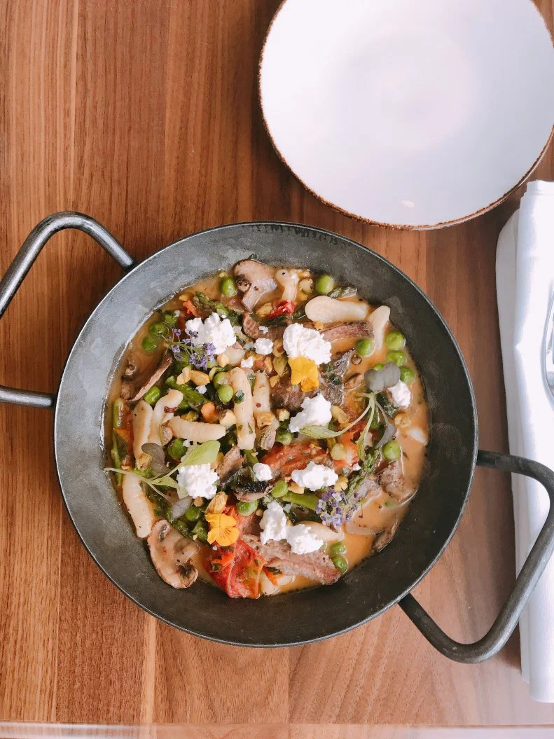 Chef Kevin Korman’s new Progressive Appalachian restaurant in The Edwin Hotel reimagines traditional Southern cuisine in elevated dishes that honor the indigenous bounty of the Tennessee River Valley. It may sound like it doesn’t fit, but new cavatelli with smoked goat, spring vegetables, pistachio and farmers’ cheese is a prime example of what he’s trying to do. Using one of the most well-known cooking techniques in the region, barbecue, Korman smokes the goat (“The most-consumed red meat in the world,” he says.) until tender and pulls it, lightening it up with butter-emulsified vegetable stock, lots of fresh herbs and vegetables like asparagus, spring peas and mushrooms. It’s all tossed together with the pasta shells and garnished with crushed pistachio and the fresh farmers’ cheese.