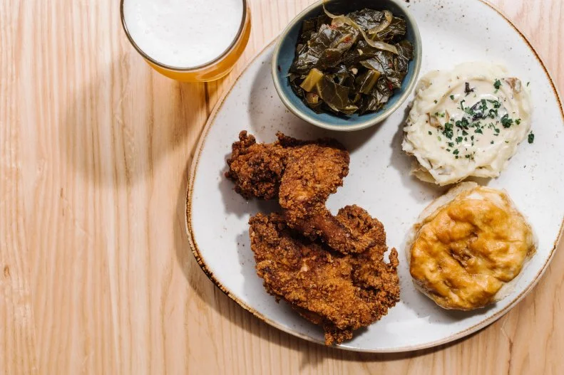 If the name Chicken + Beer sounds familiar, it’s because Chris “Ludacris” Bridges has an album with the same name. He’s also involved with this restaurant, in Hartsfield-Jackson Atlanta Airport’s concourse D; he co-owns it and developed the bourbon-maple syrup for one of his favorite dishes – Luda’s Chicken + Waffles, with fried chicken and a sweet potato and pecan chutney.