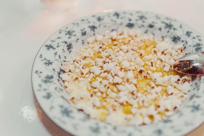 Pharrell Williams paired up with restauranteur David Grutman to create Swan, a restaurant just as stylish as its hip neighborhood, Miami’s Design District. Enjoy playful small plates indoors or outdoors, like Pharrell’s favorite, Corn Corn Corn, a trifecta of creamy polenta, sweet corn and a popcorn topper.