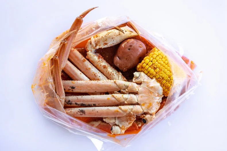 It’s a choose-your-own-adventure dinner at Angry Crab Shack. Options include crawfish, blue crabs and shrimp (heads on or off). Optional additions include sausage (YES!), corn (yes!) or potatoes (of course!). Then the kitchen adds your choice of spices to your predetermined heat level and an indeterminate, but large amount of butter, all served it up in a steamer bag right to your table which is lined with craft paper so that you can be as messy as you want.