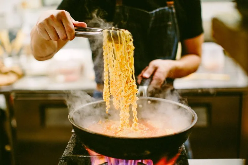 We loved this image of head chef Justin Park cooking ramen noodles for a spicy kimchi dish at Drunken Tiger. This is food to drink by, and a party atmosphere prevails as the karaoke machine hums and the night saunters on. Photo: Matt Le