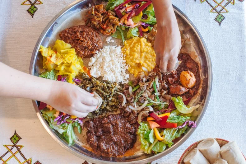 Family-owned and -operated for over two decades, Cafe Lalibela is beloved for its delicious vegetarian options and signature Ethiopian coffee. Served on puffy injera bread, the dishes are ideal for sharing.