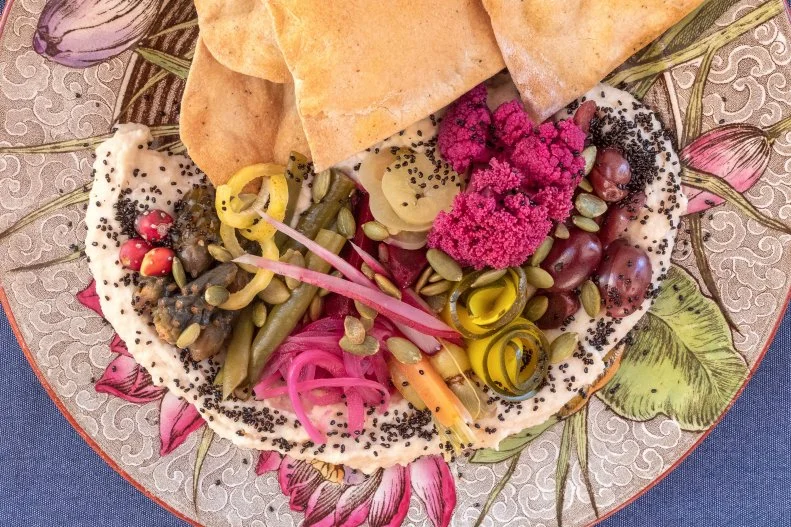 Chef Tamara Stanger is an artist, and her clarity of vision is evident in the dishes that she has created for Cotton & Copper. Her thoughtfully crafted and plated entrees are served on antique-patterned plates, and include both foraged and locally sourced, hand-picked ingredients. This beautiful O'odham bean spread is made with tepary beans, which have been local to this area since pre-Columbian times. The plate is studded with mildly pickled vegetables that include cholla cactus buds.