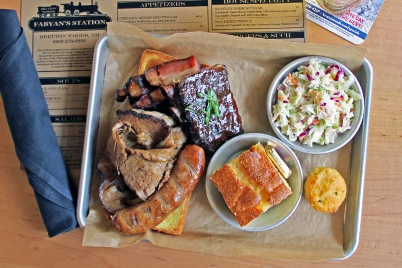 Fabyan’s, housed in a vintage train depot, in Bretton Woods, is an ideal stop for authentic BBQ. Their heart BBW platter entails the spot’s famous house-smoked pork ribs, with a choice of sauces: Tangy Carolina, Fabyan’s House or the popular Funky Sweet & Spicy sauce (made with fermented Korean chile paste). The platter also comes with pork belly, brisket and sausage, allowing guests to get a real feel of the meat sweats in one sitting.
