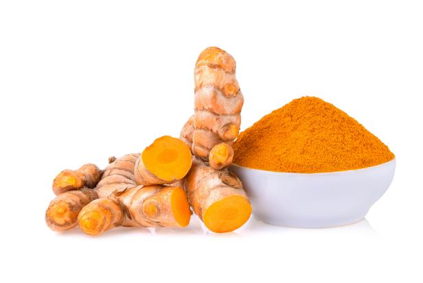 Turmeric roots with turmeric powder isolated on white background