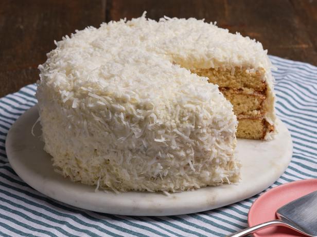 Coconut Cream Poke Cake with Coconut Whipped Cream Frosting