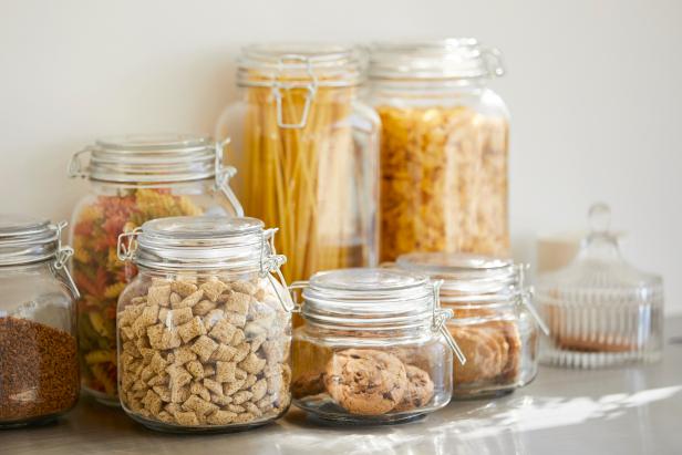 Close-up of various food in airtight jars. Groceries are seen through glass containers. Eatables are on table.