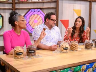 Judges Katie Lee, Nacho Aguirre, and Carla Hall sample Girl Scout Cookies, as seen on Girl Scout Cookie Championship, Season 1.