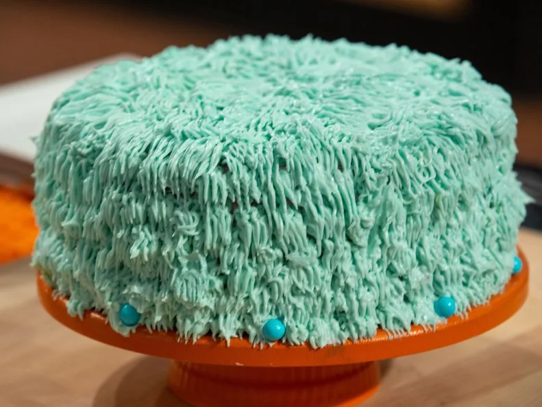 Sam's final dish - CARAMEL,WHITE CAKE WITH CARAMEL FILLING AND CHERRY BUTTERCREAM,TWIST: CANNED DARK SWEET CHERRIES, as seen on Kids Baking Championship, Season 8.