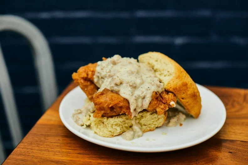As you might guess from its name, this popular Nashville counter-serve spot highlights the owners’ passion for biscuits. Chef-partners Karl and Sarah Worley started Biscuit Love as a truck before opening multiple brick-and-mortar locations around town. Guests can pick and choose from a wide selection of biscuit-hugged fare, from burgers and ham to French toast, but the East Nasty is one of the perennial fan favorites. Essentially a Nashville take on the gravy-smothered Nasty Biscuit, this version features a fried boneless chicken thigh topped with aged cheddar and sausage gravy, squeezed within a flaky buttermilk biscuit.