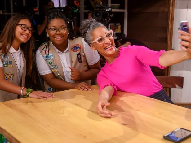 Judge Carla Hall takes a selfie with Girl Scouts Persya Perez and Bryana Turner, as seen on Girl Scout Cookie Championship, Season 1.