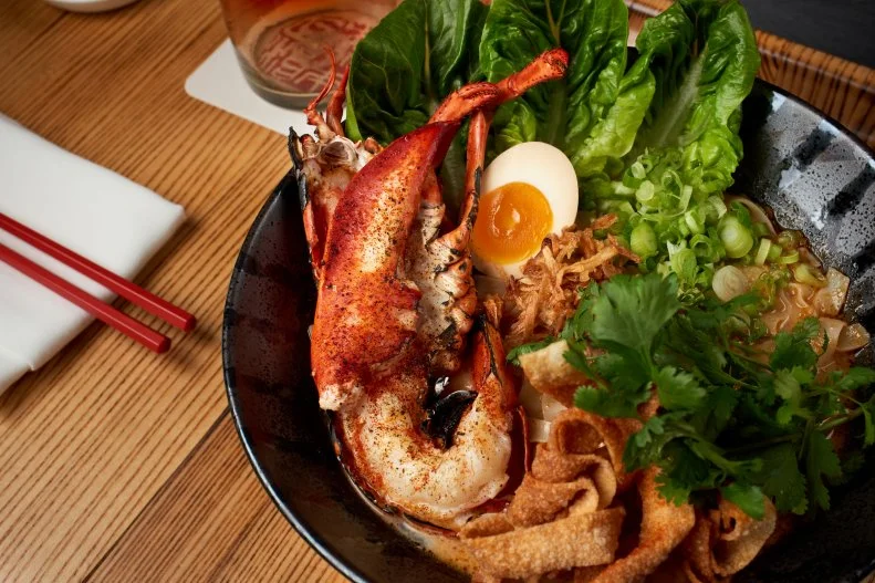 If you’re from a big city, you’ll think of Iron Chef Masaharu Morimoto’s foods as artful presentations served in subdued minimalistic environments. At Disney Springs, his food is served in a grand, indulgent space that makes meals feel equally grand and indulgent. At <a target="_blank" href="http://patinagroup.com/morimoto-asia">Morimoto Asia</a>, the chefs within the glass-walled kitchen or at the second-floor sushi bar will be simmering the stock for a lobster Singapore laksa soup, stir-frying lo mein noodles with steak; rolling eel and avocado with rice and seaweed wrappers; or stacking chilled lobster with sashimi, raw oysters and shrimp cocktail into a tower. You can go full-on Pan-Asian with a soft-shell-crab bao, and cater to the less adventurous in your group with a Chinese Caesar salad. Everyone will smile with a platterful of spareribs, doused in a sweet hoisin-chile glaze.