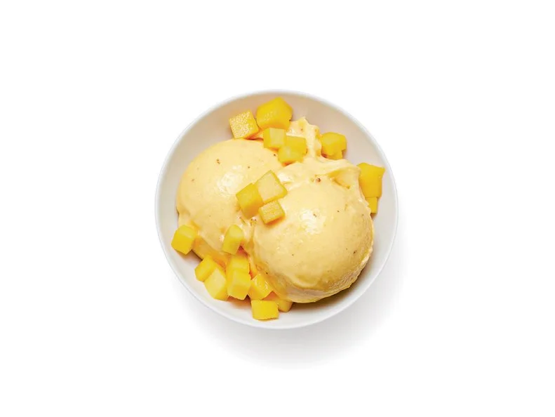 Freeze 2 sliced bananas and 1 diced mango until firm, at least 4 hours. Puree in a food processor with 3 tablespoons agave syrup, 1/2 teaspoon grated ginger and a pinch of salt, scraping down the sides as needed, until thick and smooth, 3 to 5 minutes. Top with chopped mango.