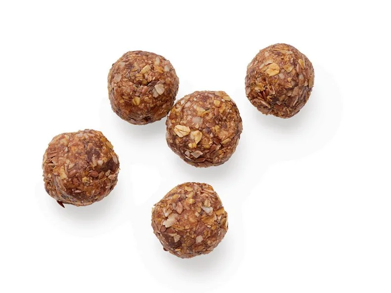 Spread 2 cups rolled oats on a baking sheet; bake at 350˚ until lightly toasted, about 15 minutes. Transfer to a food processor and pulse with 2 cups unsweetened flaked coconut until coarsely ground. Add 1 cup almond butter, 1/2 cup bittersweet chocolate chips, 1/4 cup honey, 1 tablespoon each chia seeds and flaxseeds, 3/4 teaspoon vanilla and 1/2 teaspoon kosher salt. Pulse until the mixture comes together. Roll tablespoonfuls into balls. Chill until firm, at least 2 hours.