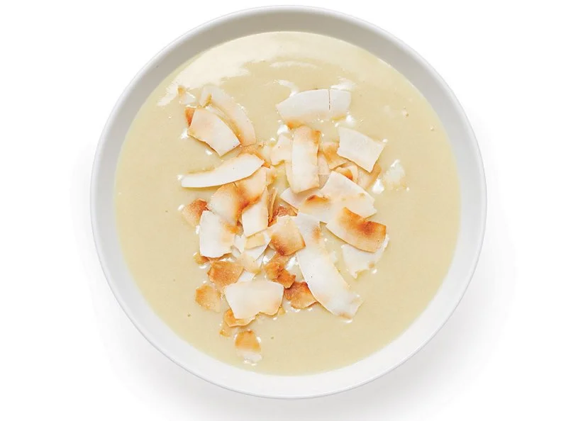 Dissolve 1/4 cup light brown sugar in 1 tablespoon water in a saucepan over medium heat. Cook, swirling the pan, until slightly darker, 3 to 5 minutes. Whisk in 2 cups oat milk. Whisk 1 egg with 2 tablespoons cornstarch in a medium bowl until smooth; whisk in 1/2 cup of the warm oat milk mixture, then add the mixture to the pan with the remaining oat milk. Whisk in 1/2 teaspoon each salt and vanilla and bring to a boil, stirring. Divide among 4 bowls; press plastic wrap onto the surface of each. Refrigerate until set, 4 to 6 hours. Top with toasted coconut flakes.