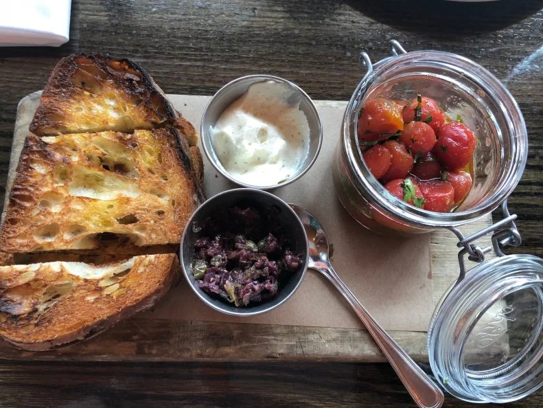 Late-night pizza is a must in any college town, but you won’t find wan, half-hearted pies at <a target="_blank" href="http://maniosteria.com/">Mani Osteria</a>. Instead you’ll find the wood-fired kind, typical of Italy, made with San Marzano tomatoes and fior de latte cheese. Handcrafted pastas, antipasti, soup and salad make this the perfect place to come with a large group to share food, stories and a bottle of one of the small-production wines they highlight on the menu.