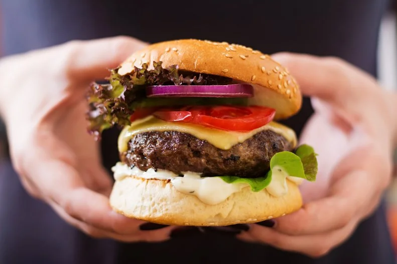 A juicy burger is a great way to replenish muscles and iron stores following a workout but sinking your teeth in this slow-to-digest, high protein food is not a good idea in the hours leading up to exercise.  
