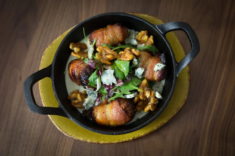 Visually, <a target="_blank" href="https://www.hotelvalleyho.com/zuzu">Zuzu</a> is a modern take on the classic, all-American 1950s hotel restaurant. And then you sit down to eat. Oxtail pappardelle with foie gras, forbidden rice with BBQ eel and pork belly, chorizo-stuffed and bacon-wrapped dates, and seared diver scallops with lobster butter — these are not the mainstays of yesteryear, daddy-o. They’re the culinary creations of talented chef Russell Lacasce, who balances out the bold menu with crowd pleasers like Kennebec chips with French onion dip.