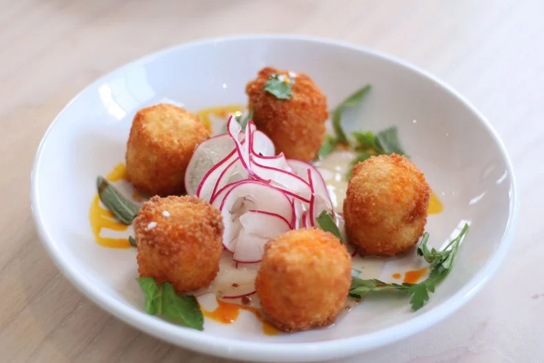 There’s a sense of community woven into the fabric of Hathorne, a casually upscale spot on Nashville’s West Side. It occupies a former church fellowship hall, where potlucks and gatherings from the past have inspired owner John Stephenson to create a community-minded restaurant for right now. The menu is vegetable-forward, with dishes like heirloom carrots with sorghum popcorn and crispy redfish on a pile of mustard greens, served family-style. During their Joyful Hour, weekdays from 5 to 7 p.m., you’ll find deals, like $10 off bottles of wine and $5 small plates, including fried vegetables with aioli, pork cracklins with mole, and house pickles. Even their signature house burger, served with frites or a green salad, is a filling nosh at only $10. 