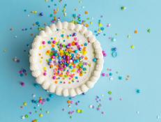 Birthday cake top view with colorful sprinkles