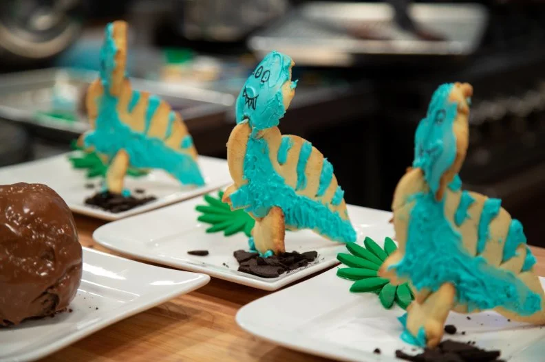 Sam's final dish - T-REX LEMON LIME SUGAR COOKIE WITH VANILLA ROYAL ICING,WITH BROWNIE  'EGG Äù WITH MILK CHOCOLATE COATING , as seen on Kids Baking Championship, Season 8.