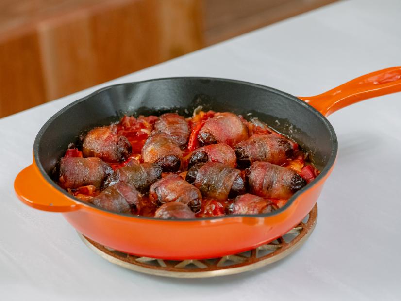 Michael Symon features Chorizo Stuffed Dates Wrapped in Bacon in Red Pepper Sauce, as seen on Food Network Kitchen Live.