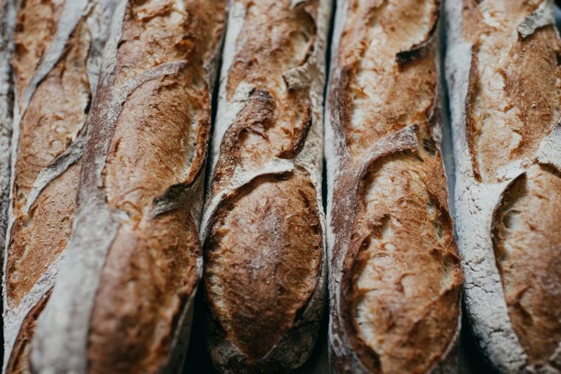 Baker Graison Gill started baking right after he moved to New Orleans in 2009, soon outgrowing the ovens of his Royal Street apartment, then a commercial kitchen, until he opened <a target="_blank" href="http://bellegardebakery.com/">Bellegarde Bakery</a>. Though he’s always been meticulous about ingredient sourcing, it wasn’t until around 2013 that Gill gave much thought to flour. When he couldn’t find the kinds of freshly milled flours he wanted to work with, Gill took matters into his own hands. Today, Bellegarde mills 3,500 pounds of flour per week on two 40-inch stone mills to produce 7,000 loaves of bread per week. Each of the naturally leavened, slow-fermented loaves is made by hand and baked in a hearth oven. Gill describes the baguette, made with a blend of organic red and white wheats, as crispy, cotton and wheat-y, ideal for pairing with deli meats and hard, sharp cheeses. You’ll find the breads and grains at restaurants around town, including Turkey and the Wolf and La Petite Grocery. The freshly milled flours can also be purchased at the bakery; they take starring turn in local kitchens’ hand made pastas and in Gill’s own line of pastas (which happily, can be ordered online).
