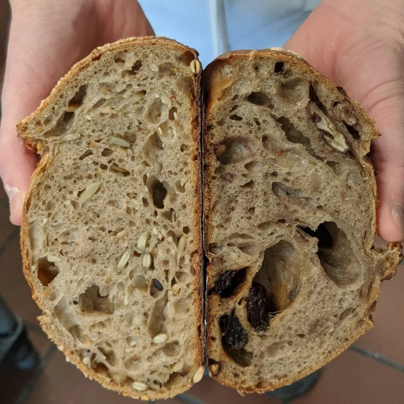 After briefly working as an engineer in Boston, Daisy Chow found her true passion in baking. It wasn’t as much of a leap as it might seem on paper; Chow grew up outside Dallas in her parents’ Chinese restaurant, so she’s always felt at home in the kitchen. After working as a pastry chef in Boston, she began her bread baking career at Clear Flour Bread where she fell in love with the simplicity of the craft. After honing her skills there for 15 years, she struck out on her own and opened <a target="_blank" href="http://www.breadandstuff.com/">Breadboard Bakery</a> in Arlington in 2019. (Breadboard, which is a base for prototyping and combining electrical components, is a nod to her engineering days.) At the charming neighborhood bakery, Chow’s hand-crafted breads incorporate as much regional, freshly milled flour as possible. To wit, the classic sourdough, rye, seeded (as shown above left) and raisin pecan (as shown above right) loaves all showcase 100% Maine Grains. The Danish rye is particularly standout. It’s a dense, moist loaf that Chow says is meant to be sliced thin and eaten with plenty of salted butter (though it’d also be perfect for anchoring a DIY smørrebrød spread at home). Maine Grains’ whole wheat flour also take a starring turn in Breadboard’s pastries, including the staff favorite croissants and an ultra-flaky cinnamon roll made with croissant dough.