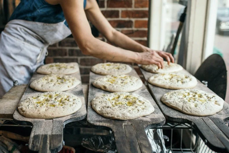 Richmond’s <a target="_blank" href="http://www.subrosabakery.com/">Sub Rosa Bakery</a> started out as an underground subscription bread service in 2009, eventually converting to brick and mortar in 2012. Brother-and-sister team Evrim and Evin Dogu focus on freshly milled, regional grains that are stone-ground in-house, all of which take a starring turn in their naturally leavened breads and pastries. Don’t miss the pide, a fluffy-yet-substantial flatbread that nods to the Dogus’ Turkish roots and comes topped with olive oil and Nigella and sesame seeds (pictured above). The light rye is another stand-out, a subtly peppery loaf that is balanced by hints of honey, cocoa or a sweet earthiness, depending on the varietals used. On the pastry front, don’t miss the sour-cherry-and-pistachio croissant or the Poğaça, a savory Turkish pastry fashioned after the Dogus’ grandmother’s recipe.