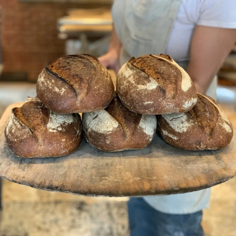 For fifteen years and counting, Blair Marvin and Andrew Heyn have earned an industry-wide reputation for the small-batch, hearth-baked breads they bake on their 10-acre property in the north-central Vermont town of Elmore. When they discovered freshly milled flours and heritage grains, they decided to go all-in and mill their own flour for <a target="_blank" href="http://www.elmoremountainbread.com/">Elmore Mountain Bread</a>. Heyn, along with Fulton Ford (who helped found Boulted Bread in Raleigh, North Carolina), built a custom 40-inch, granite mill and in turn, developed New American Stone Mills. Today, there are more than 75 New American Stone Mills around the world. Though Marvin bakes just twice a week, Elmore Mountain produces 700 loaves each day that are destined for local stores and restaurants, particularly in nearby Stowe. Look for the Vermont Redeemer, a single variety wheat sourdough; Thornhill Rye, a sourdough made with stoneground local rye; and Marvin’s favorite, Andama, a traditional New England-style bread in which heirloom cornmeal is cooked into polenta, combined with wheat flour, and sweetened with local dark maple syrup (instead of molasses). 