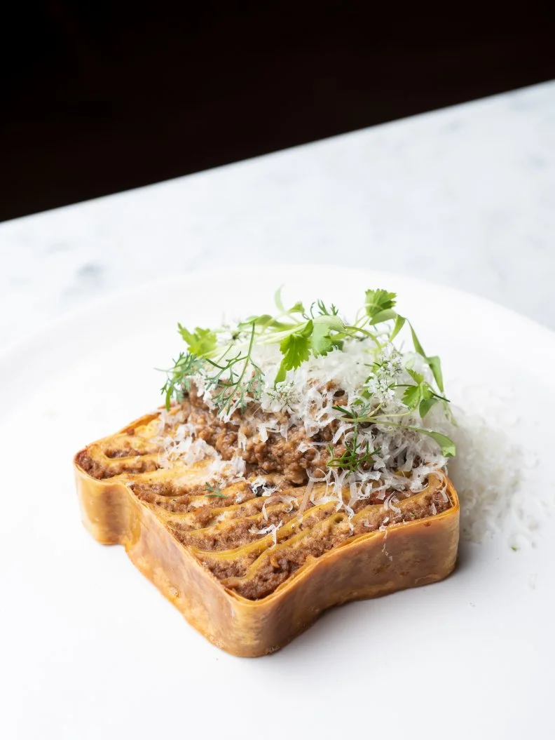 Opened by Top Chef winner, Mei Lin in late 2018, Nightshade is still one of the most coveted tables to score in Los Angeles’ oversaturated restaurant scene. Lin has the Midas touch with every dish on the menu—her Nantucket Bay scallops in spicy coconut vinaigrette make a strong impression on even the most jaded diners—but the Mapo tofu lasagna is one of the top-sellers, for good reason. Slices of egg noodles are delicately layered between an incomparable Sichuan pepper pork ragu with strings of tofu cream and a hearty dose of parmesan sprinkled on the top. Hands down, it’s one of the most genre-bending pasta dishes we’ve ever seen. 