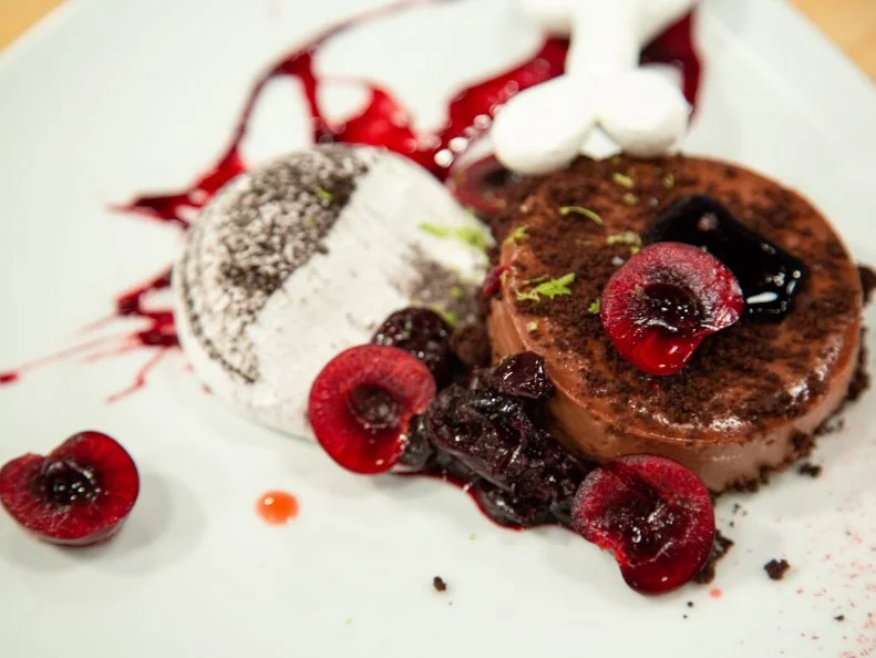 Sohrob's final dish - SOHROB: Black Forest Cheesecake with Pavlova Skate Ramp and Cherry Compote, as seen on Spring Baking Championship, Season 6.
