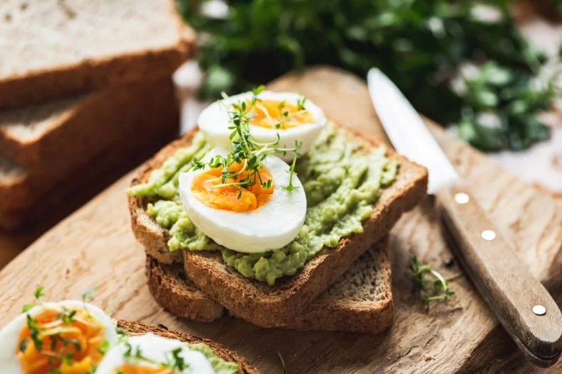 It's not just what you eat, but what's included at breakfast. Michelle Loy, MPH, MS, RDN provides personalized nutrition therapy at Go Wellness says "I've learned that I must include some source quality protein, usually eggs, plain yogurt, or nut butter every day for breakfast." This is because protein is digested more slowly, so it helps keep you satisfied for longer after my morning meal. "Not only does it keep the hunger pangs at bay, but it also helps stabilize my energy levels, keeping me more focused while working," says Loy.